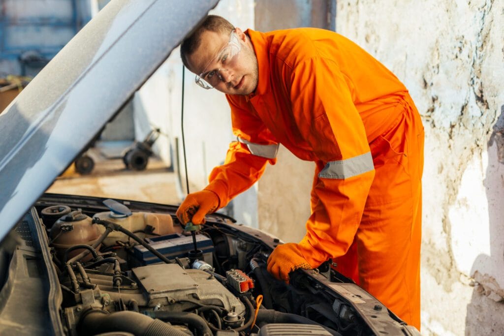 Automotive technician servicing engine covered by vehicle protection plan